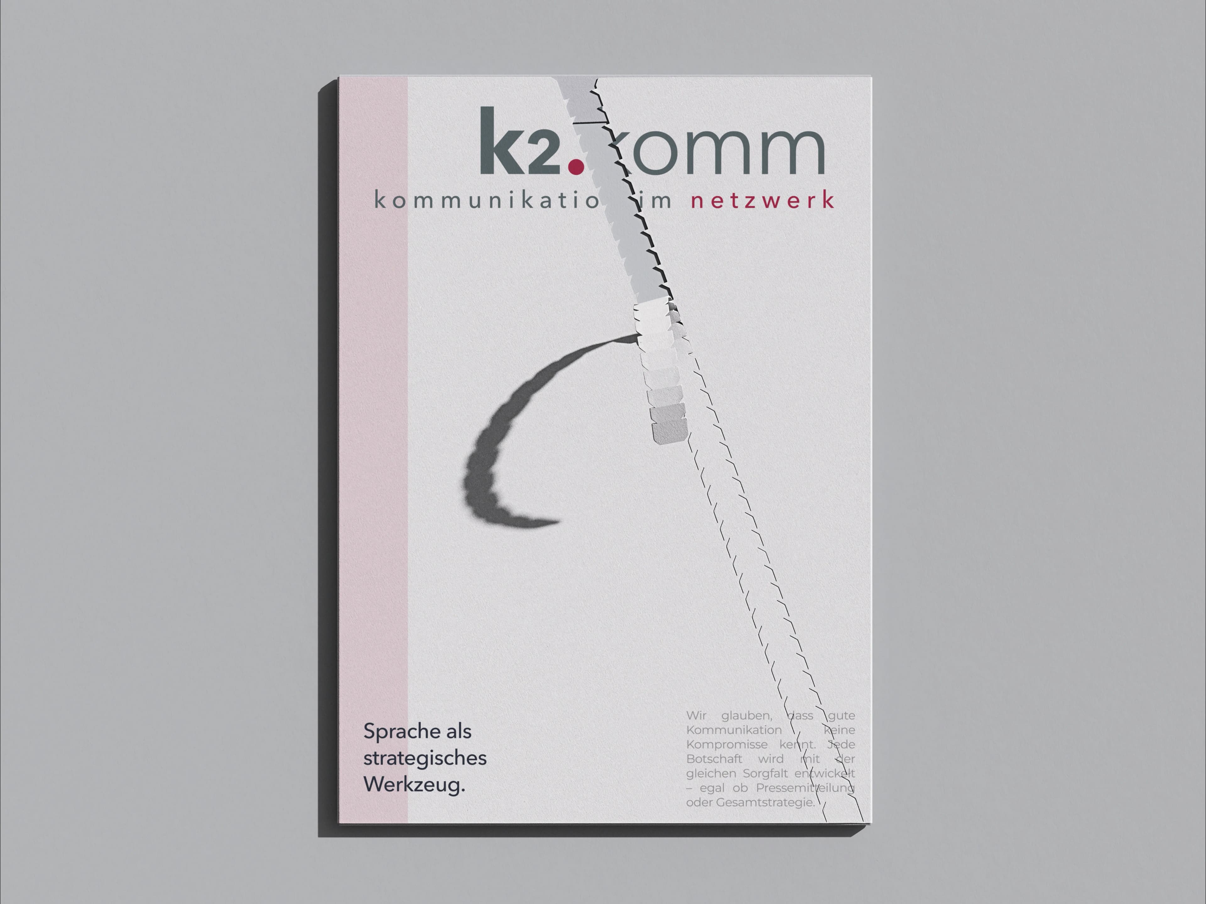 k2.komm brochure cover with claim and graphic